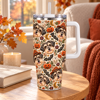 Daisy Halloween folk art tumbler beside a book and candle in a cozy autumn reading nook