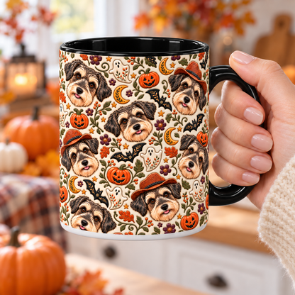 A woman holding the black handle of a personalized dog photo mug with full-wrap Halloween folk art artwork