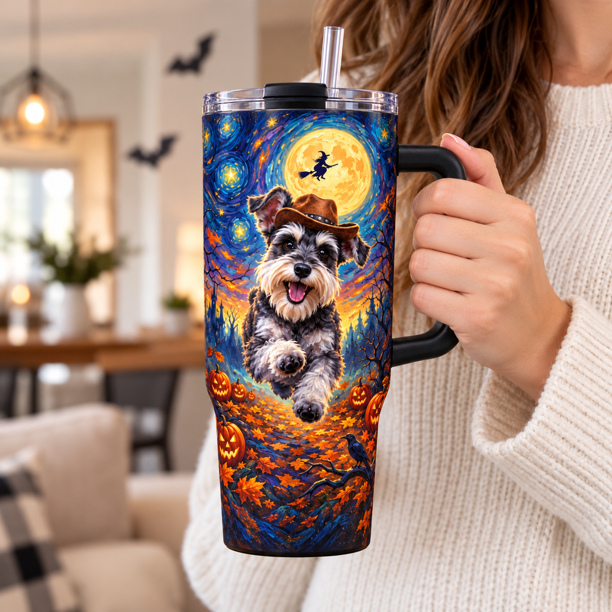 A woman holding the 40 oz Halloween dog tumbler by its handle